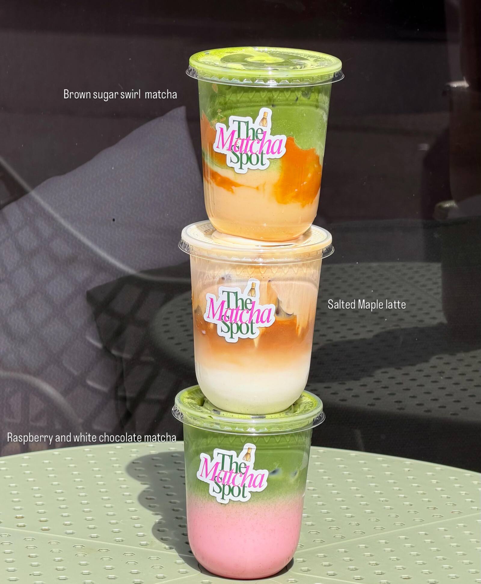 Stack of three signature drinks - brown sugar swirl matcha, salted maple latte, raspberry and white chocolate matcha